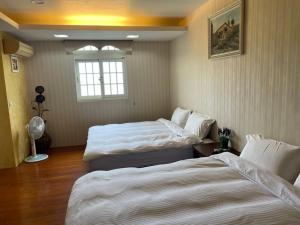 礁溪伊豆温泉民宿客房内的一张或多张床位
