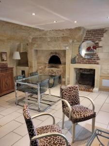 罗什科尔邦Le Gite de la Loire的客房设有桌椅和壁炉。