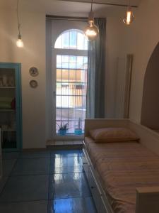 兰恰诺IL MELOGRANO La Casa nel Vicoletto的一间卧室设有一张床和一个大窗户