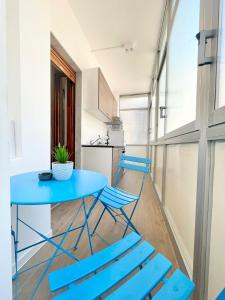 巴里BARIROOMS - Melo Suites的带厨房的客房内的蓝色桌椅