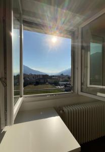 奥斯塔Settimo Cielo Apartment Aosta CIR 0199的窗户配有暖气,享有城市美景