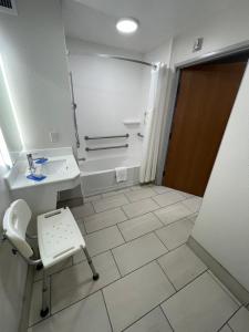 拉斯维加斯拉斯维加斯快捷假日酒店及套房的浴室配有卫生间、盥洗盆和浴缸。