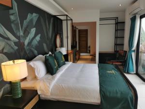 波尔多·格尼拉Villa Escarceo的卧室配有带绿色枕头的大型白色床