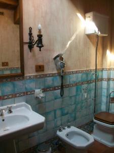 丽都迪丰迪Tenuta Vento di Mare的浴室配有水槽、卫生间和灯具。