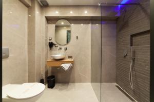 尼基季Lithos Suites - Nikiti Halkidiki的浴室配有卫生间、盥洗盆和淋浴。