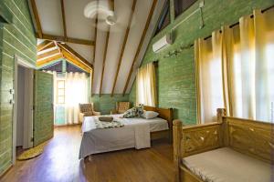 拉迪格岛Ambiance Villa的一间设有两张床的卧室,位于带绿色墙壁的房间