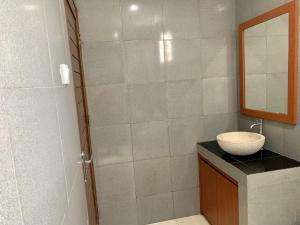 努沙杜瓦Davit Guesthouse Nusa Dua的一间带水槽和淋浴的浴室
