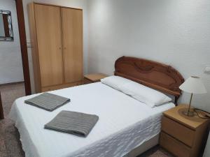 埃尔切Major del Pla 25的一间卧室配有一张床,上面有两条毛巾