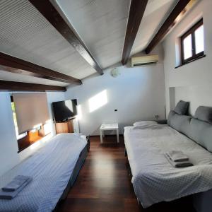 PlavjeApartma Rok的一间卧室配有两张床和一台平面电视