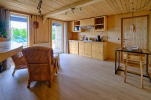 绍德方丹La tanière的厨房铺有木地板,配有桌椅。