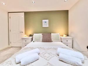 诺丁汉Luxurious Apartment in Nottingham Lace Market的一间卧室配有一张带2个床头柜的大型白色床