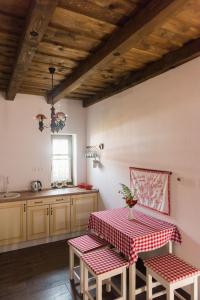 ÉrpatakZsindelyes Cottage的厨房配有一张带红白桌布的桌子