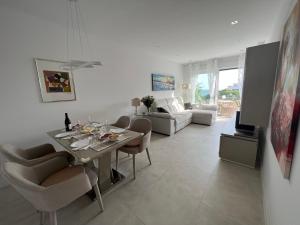 马贝拉New build modern ap 4 min walk to the beach and Marbella old town的白色的客厅配有桌椅