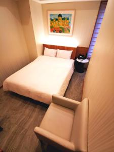 埼玉市HOTEL MOND Omiya - Vacation STAY 85327v的一间小卧室,配有一张床和一把椅子