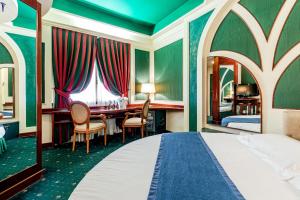 利米托迪皮奥尔泰洛Hotel Motel Miami的酒店客房带一张床铺、一张书桌和一间卧室
