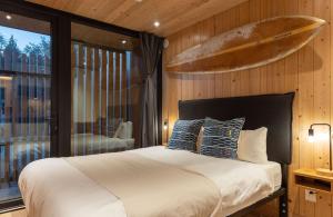 托菲诺麦肯齐海滩度假酒店的卧室配有一张床铺,墙上设有冲浪板