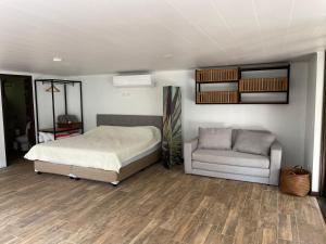 塔尔科莱斯Loft Mágico en Nativa Resort的一间卧室配有一张床和一张沙发