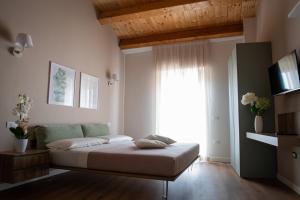 圣马蒂诺－因彭西利斯Dimora Donna Dora - Albergo Diffuso的一间卧室设有一张床和一个大窗户
