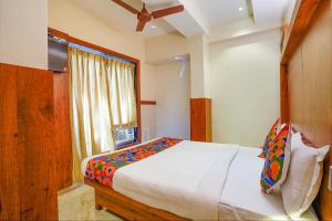 孟买FabExpress Super 7 Inn的一间卧室设有一张大床和一个窗户。