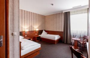 弗罗茨瓦夫巴斯洛弗罗茨瓦夫高级酒店的酒店客房设有两张床和窗户。