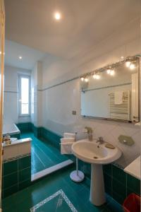 罗马ROMAMOREMIO的绿色和白色的浴室设有水槽和镜子