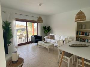 普拉亚布兰卡Villalia Capri的客厅配有白色的沙发和桌子