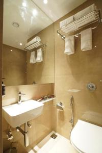 孟买Ginger Mumbai, Goregaon的一间带水槽、卫生间和镜子的浴室