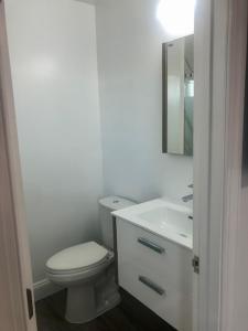 大洋城Safari Apartments的白色的浴室设有卫生间和水槽。