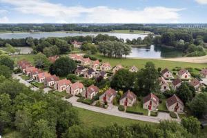 EwijkVakantiewoning Maas en Waal的享有住宅区与河流的空中景色