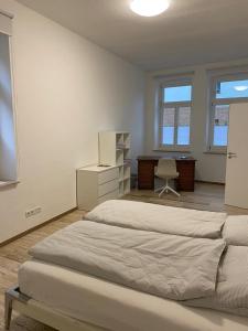瓦尔堡Apartment Van Eß Hof - Altstadt Warburg的一间卧室配有两张床、一张桌子和一把椅子