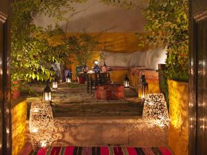干尼亚阿卡内尔精品酒店的一间设有桌子的房间,还有一些灯光和树木