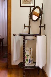 洛斯雷亚莱霍斯Casa Rural La Gañanía的镜子和一扇花瓶放在一个房间里