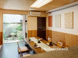 京都Kyoisuke的一间带桌椅和窗户的用餐室