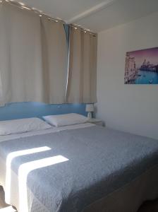 伊索拉戴里费米尼Casa Piano Ponente的一间卧室,配有一张阳光明媚的床