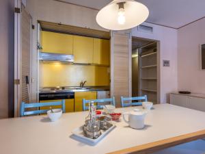 普雷圣迪迪埃Apartment Universo-1 by Interhome的厨房以及带桌椅的用餐室。