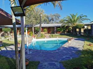 OshikangoPalmeiras Lodge Oshikango的一座房子旁的院子内的游泳池
