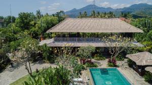 班尤温当Odiyana Bali Retreat的享有带游泳池的度假村的空中景致