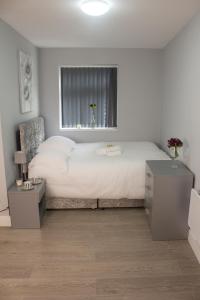 西布罗姆维奇Charming Accommodation close to Birmingham的卧室配有一张大白色床和窗户