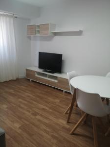 奥莱罗斯Apartamento Castelo de Santa Cruz的客厅配有电视和桌椅