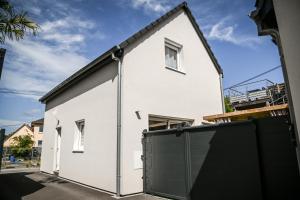 Hindisheim214 A‘coeur的一间白色的房子,设有黑色车库门