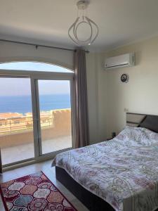 艾因苏赫纳Telal Ain Sokhna Villa的一间卧室设有一张床和一个大窗户
