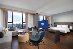武汉武汉光谷智选假日酒店的一间酒店客房,配有一张床和一台电视