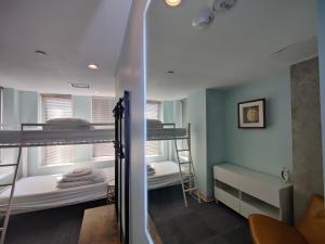 华盛顿U Street Capsule Hostel的客房设有两张双层床和镜子