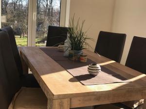 马林费尔德Das Haus am See的木制餐桌,配有黑色椅子和木桌