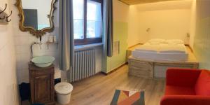 MelleOstello Antagonisti的卧室配有床、椅子和窗户。