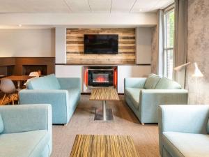 约克宜必思约克中心酒店的客厅配有2张蓝色沙发和壁炉