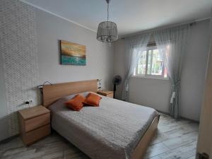 阿德耶LUX Orlando的一间卧室配有一张带两个橙色枕头的床