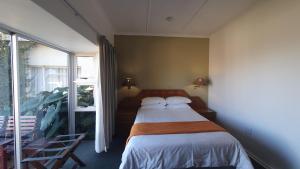 姆巴巴内Mountain View International by BON Hotels的一间卧室设有一张床和一个大窗户