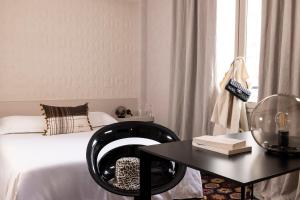 南特L酒店的一间卧室配有一张床和一张桌子及椅子