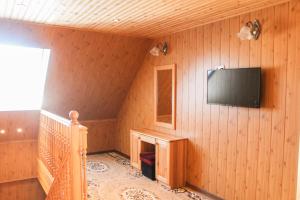 珀尔瓦Käopesa Kodumajutus的木墙上配有电视的房间